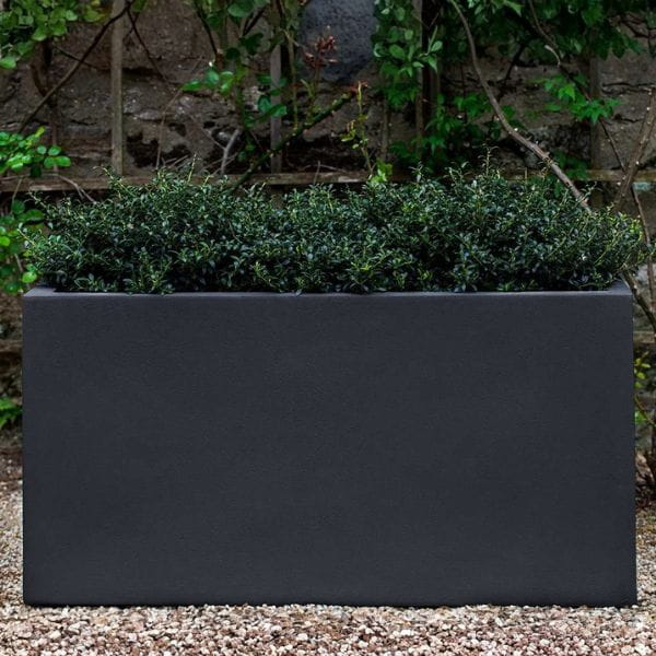 Sandal Planter 482424 S/1 in lead lite on gravel filled with plants.