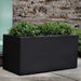 Sandal Planter 482424 S/1 in onyx black lite on concrete filled with plants.