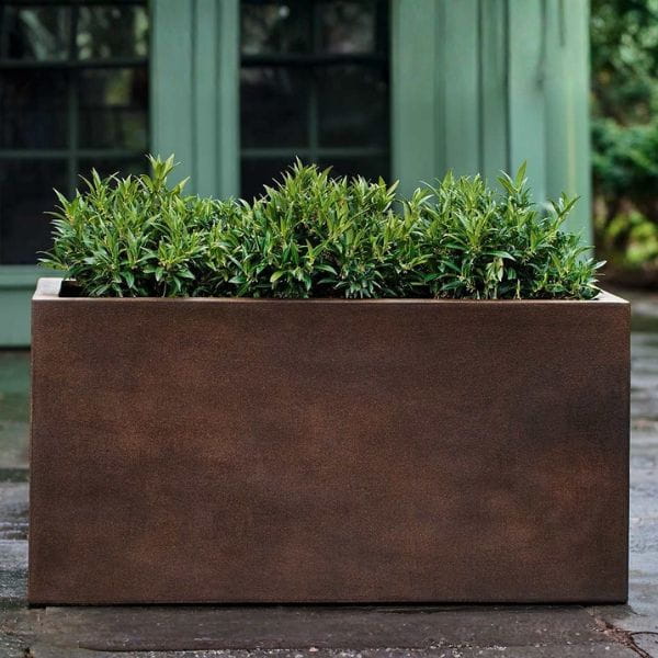 Sandal Planter 482424 S/1 in rust lite on concrete filled with plants.