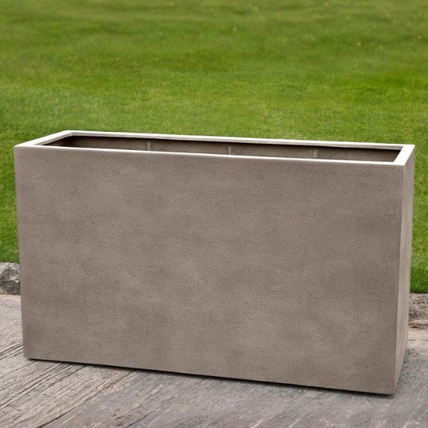 Sandal Planter 591836 S/1 in riverstone premium lite on concrete in the backyard.