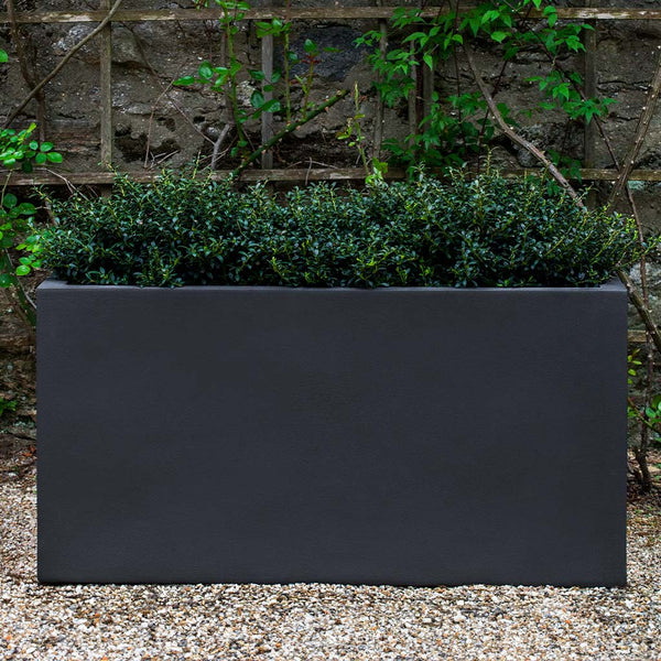 Sandal Planter 592424 S/1 in lead lite on gravel filled with plants.