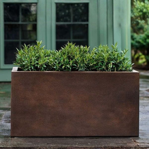Sandal Planter 592424 S/1 in rust lite on concrete filled with plants.