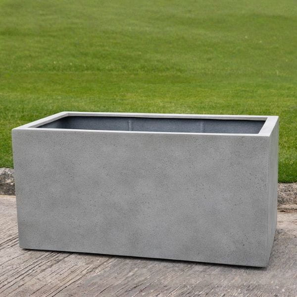 Sandal Planter 592424 S/1 in stone grey lite on concrete in the backyard.