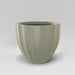 Santa Barbara Fluted Round Fiberglass Planter in satin beige against gray background.