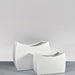 Seoul Modern Curved Rectangle Fiberglass Planter on concrete shown with two different sizes.
