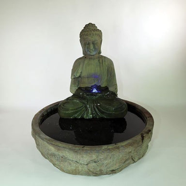 Serene Basalt Buddha Fountain against gray background.