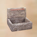 Shallow Cistern Fountain  with Copper Overflow against brown background.