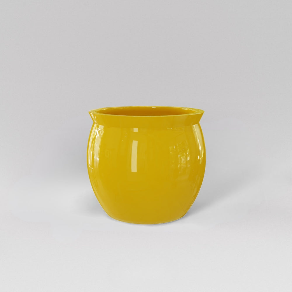 Shanghai Fishbowl Fiberglass Planter in gloss saffron against gray background.