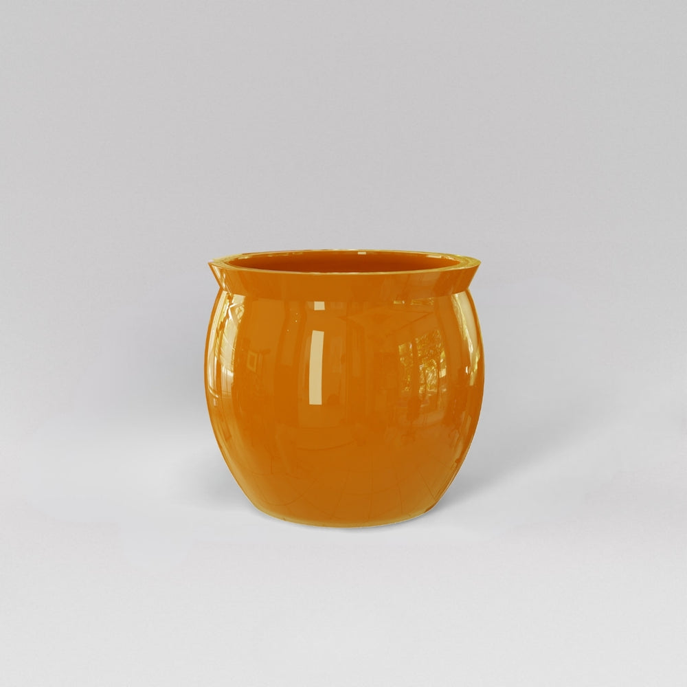 Shanghai Fishbowl Fiberglass Planter in gloss tangerine against gray background.