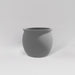 Shanghai Fishbowl Fiberglass Planter in matte cement grey against gray background.