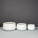 Short Hayden Tapered Round Fiberglass Planter in 3 different sizes on concrete 