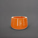 Short Hayden Tapered Round Fiberglass Planter in gloss tangerine against gray background.