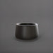 Short Hayden Tapered Round Fiberglass Planter in matte black against gray background.