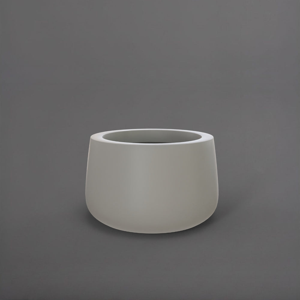 Short Hayden Tapered Round Fiberglass Planter in matte cement grey against gray background.