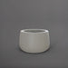 Short Hayden Tapered Round Fiberglass Planter in matte cement grey against gray background.