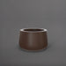 Short Hayden Tapered Round Fiberglass Planter in matte dark brown against gray background.