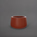 Short Hayden Tapered Round Fiberglass Planter in matte terra cotta against gray background.