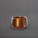 Short Hayden Tapered Round Fiberglass Planter in metallic bronze against gray background.
