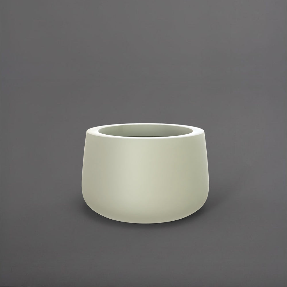 Short Hayden Tapered Round Fiberglass Planter in satin beige against gray background.