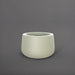 Short Hayden Tapered Round Fiberglass Planter in satin beige against gray background.