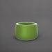 Short Hayden Tapered Round Fiberglass Planter in satin green against gray background.