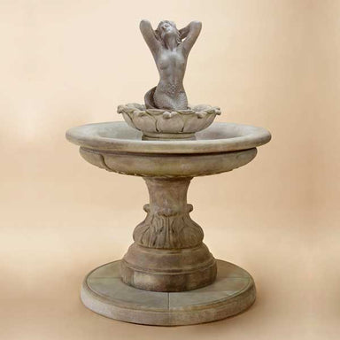 Sirena Mermaid Fountain against brown background.