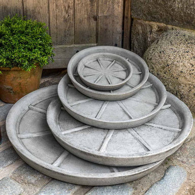 Small Campania Plant Saucers on concrete in the backyard.