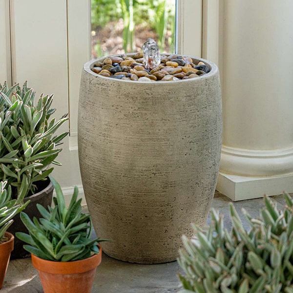 Soma Pebble Fountain on concrete beside cactus