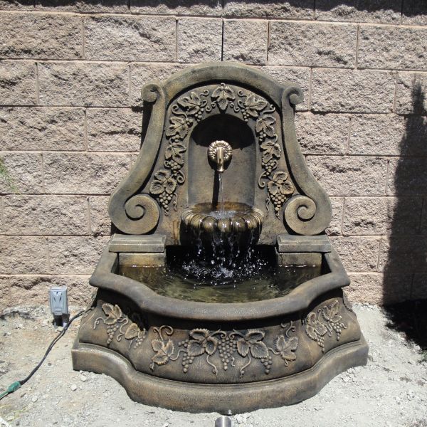 Sonoma Wall Fountain for spout in action against brick wall.