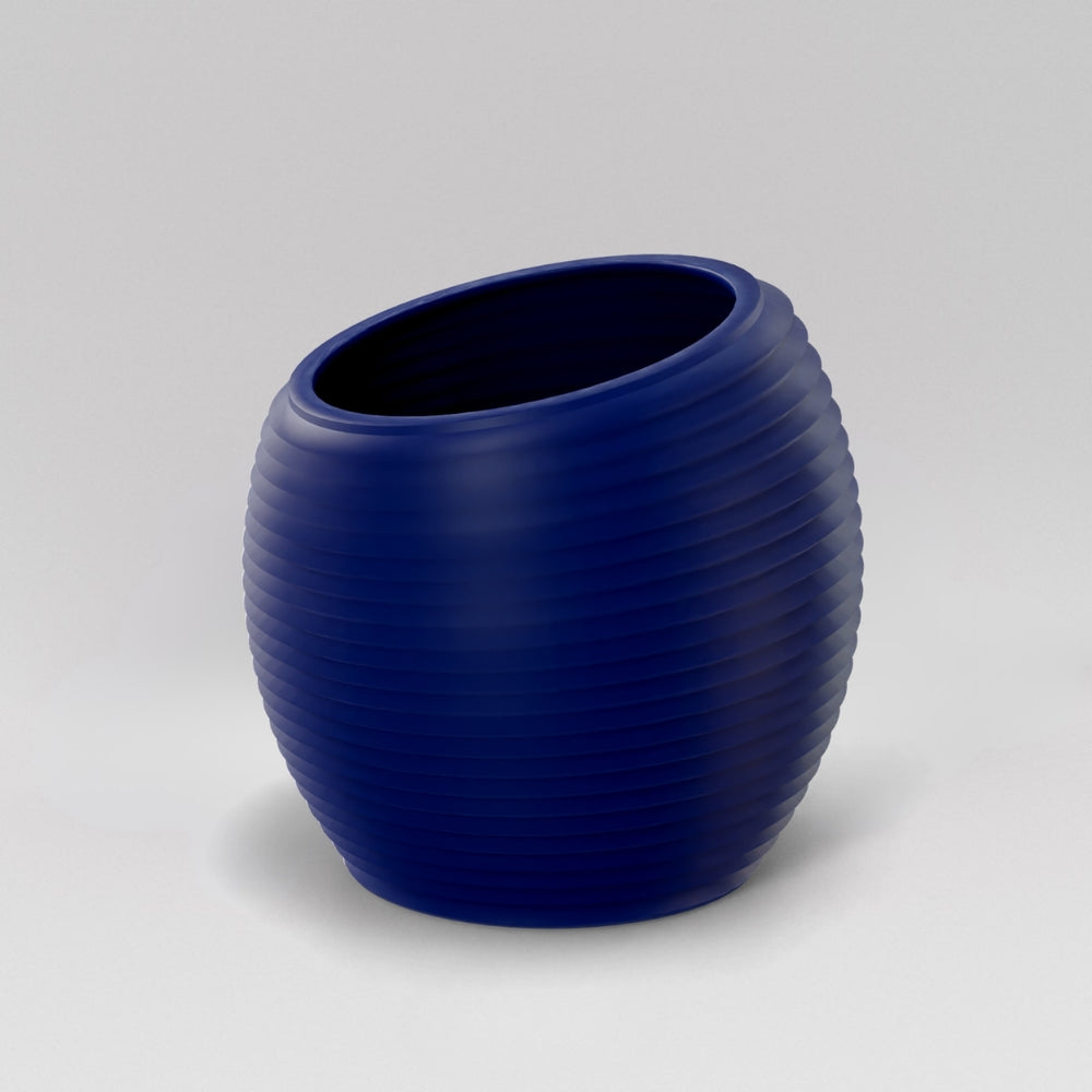 Spiral Globe Fiberglass Planter in matte cobalt blue against gray background.