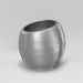 Spiral Globe Fiberglass Planter in metallic silver against gray background.