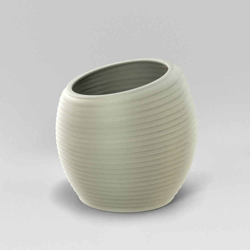 Spiral Globe Fiberglass Planter in satin beige against gray background.
