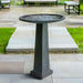 Spire Birdbath on concrete patio.