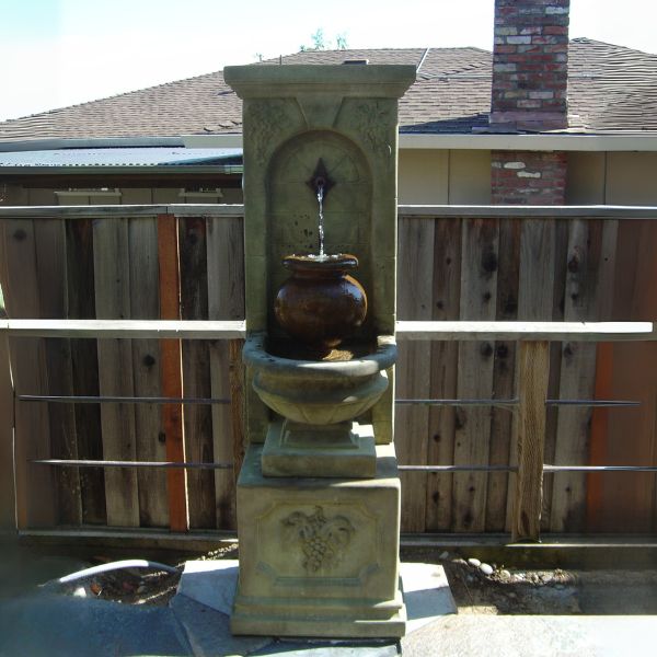 St. Helena Urn Fountain against the house.