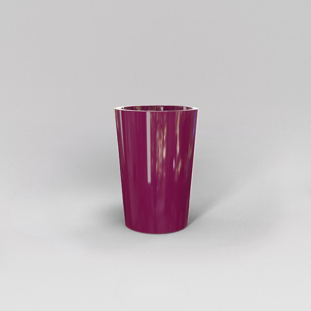 Tagel Tapered Round Fiberglass Planter in gloss eggplant against gray background.