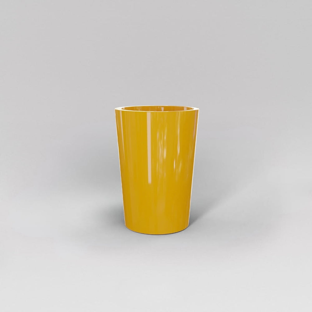 Tagel Tapered Round Fiberglass Planter in gloss saffron against gray background.