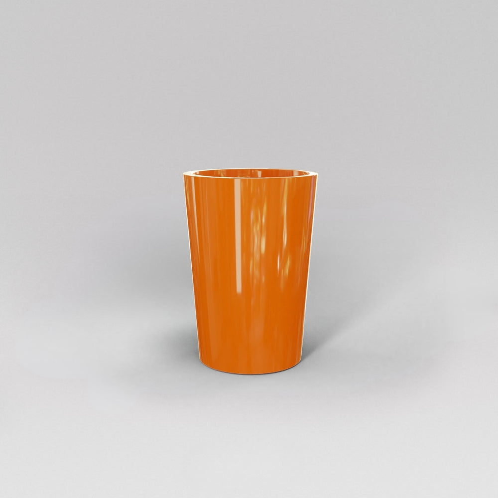 Tagel Tapered Round Fiberglass Planter in gloss tangerine against gray background.
