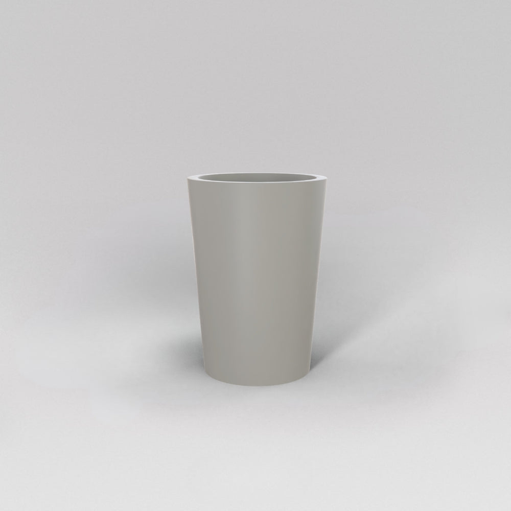 Tagel Tapered Round Fiberglass Planter in matte cement grey against gray background.
