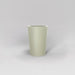Tagel Tapered Round Fiberglass Planter in satin beige against gray background.