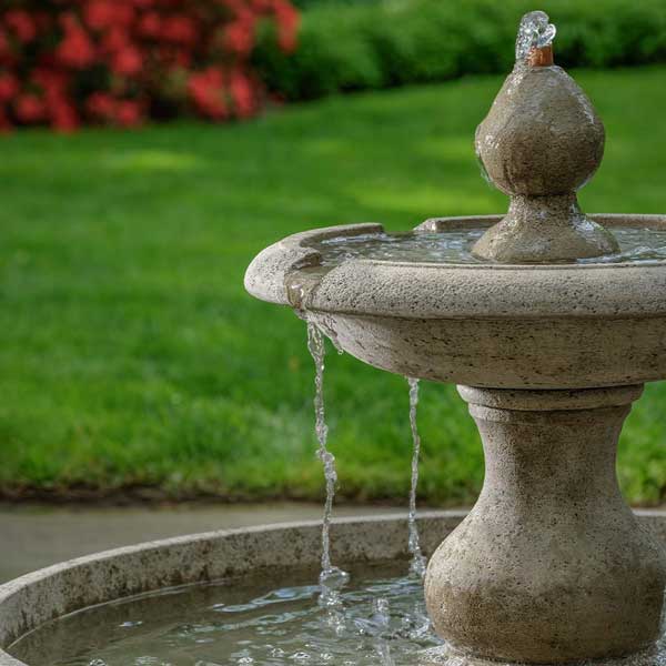 Terrase Fountain on the concrete with grass background upclose