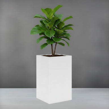 Tolga Corner Fiberglass Planter filled with plants against gray backdrop.