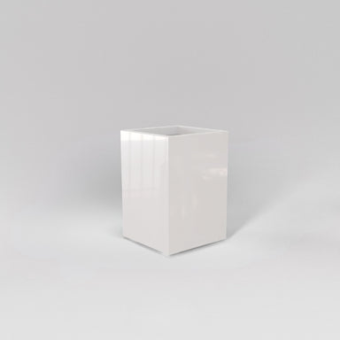 Tolga Corner Fiberglass Planter in gloss bright white against gray background.