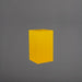 Tolga Corner Fiberglass Planter in gloss saffron against gray background.