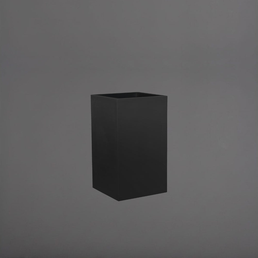 Tolga Corner Fiberglass Planter in matte black against gray background.