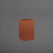 Tolga Corner Fiberglass Planter in matte terra cotta against gray background