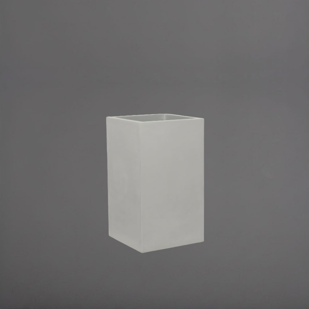 Torino Corner Fiberglass Planter in matte cement grey against gray background.