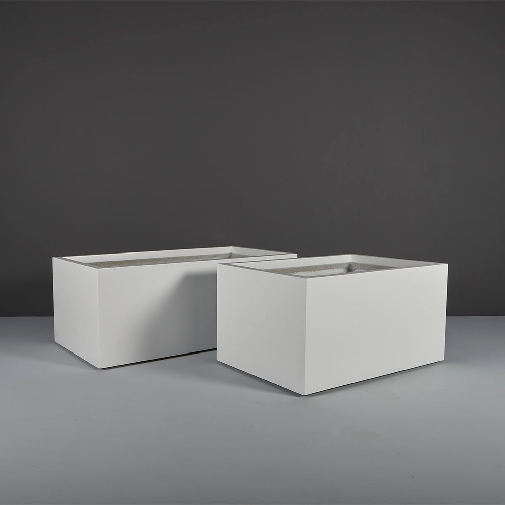 Torino Wide Rectangle Fiberglass Planter on concrete shown with different sizes.