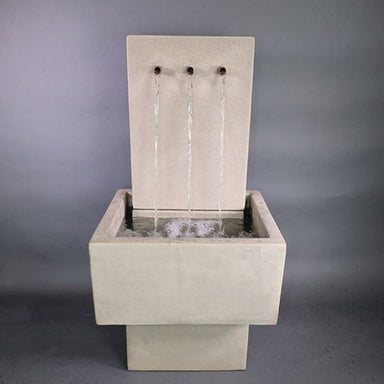 Tribus Patio Wall Fountain against gray background.