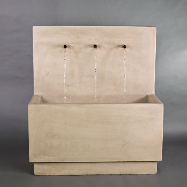Tribus Wall Fountain in french limestone in the backyard.