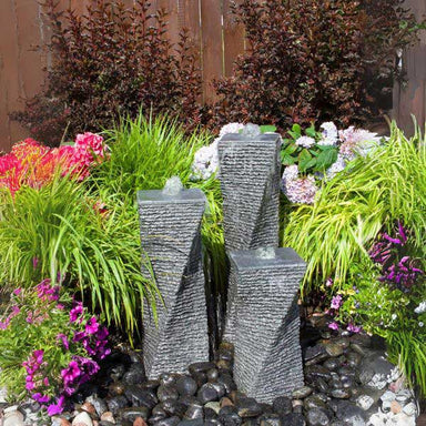 Triple Chiseled Twist Granite Fountain Kit in action in the backyard